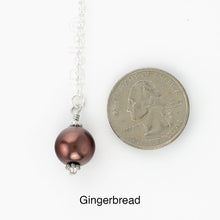 Load image into Gallery viewer, Scarf slide set extra glass pearl titled Gingerbread - view showing the pearl laying next to a quarter for size reference.
